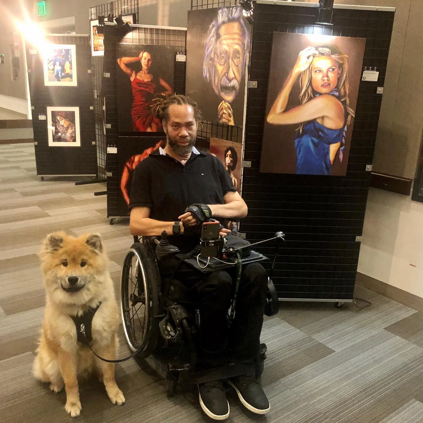 Richard in an art gallery with his dog.