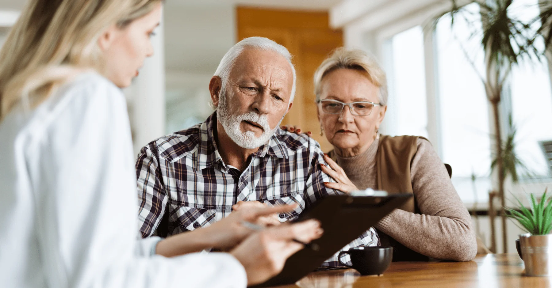 a man and a woman looking at a tablet