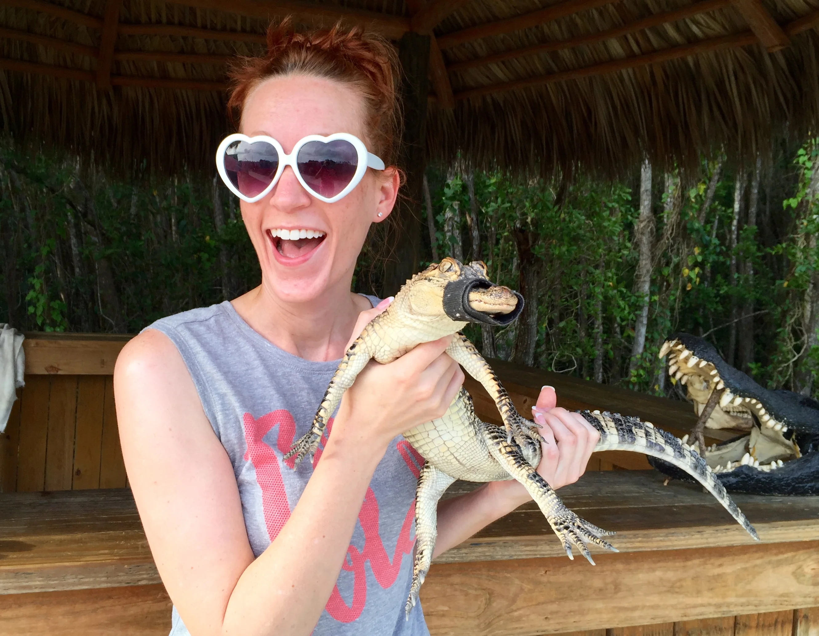 picture of a woman living with an ostomy posing with a reptile